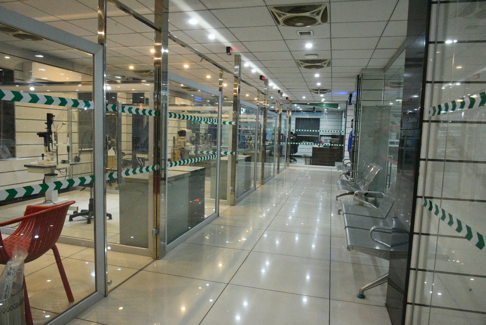 Waiting area and glass exam rooms along the clinic hallway